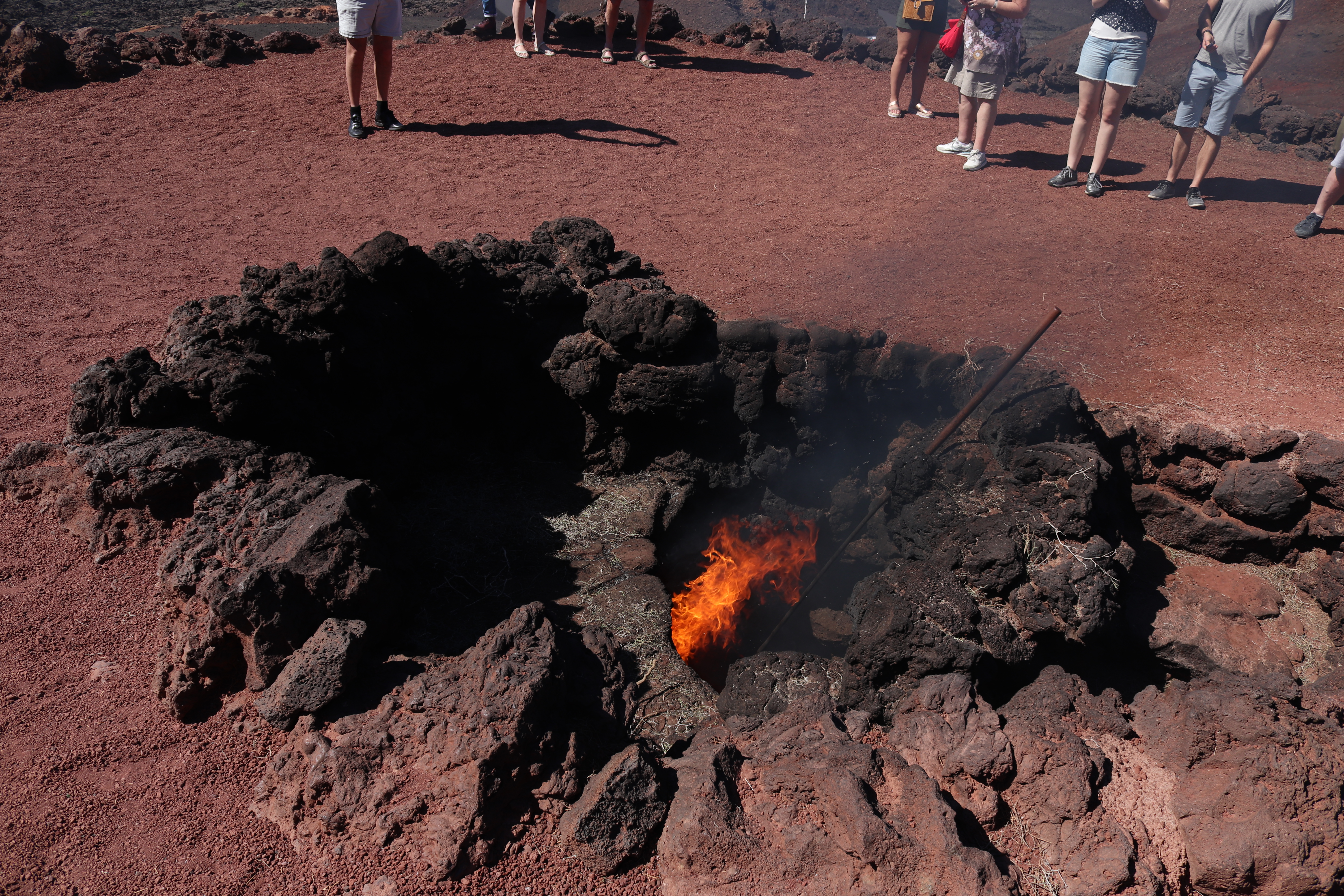 Creating fire using volcanic heat in Timanfaya National Park
