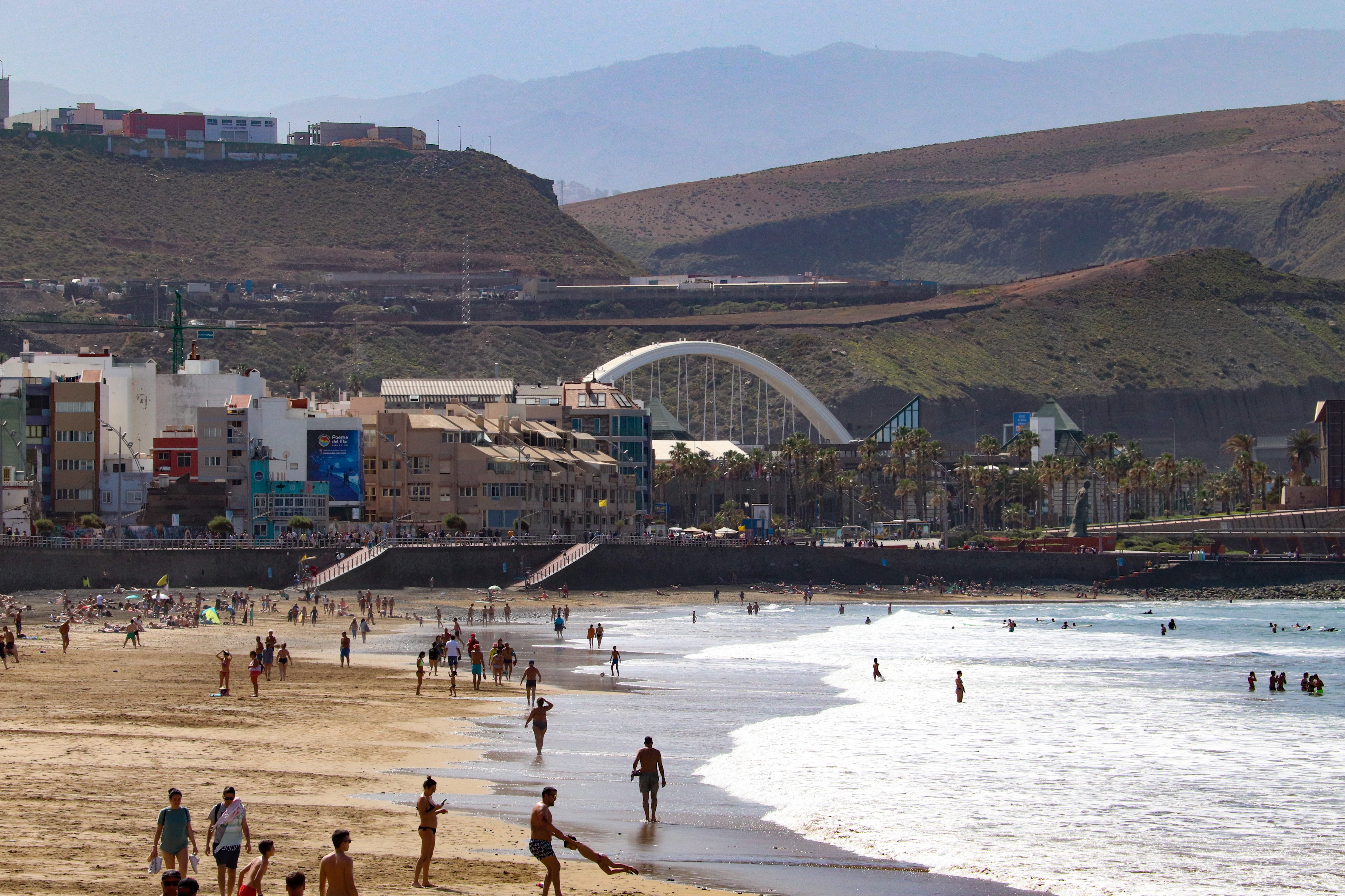 A view of the Playa de Las Canteras with the mountains of Gran Canaria visible in the distance.