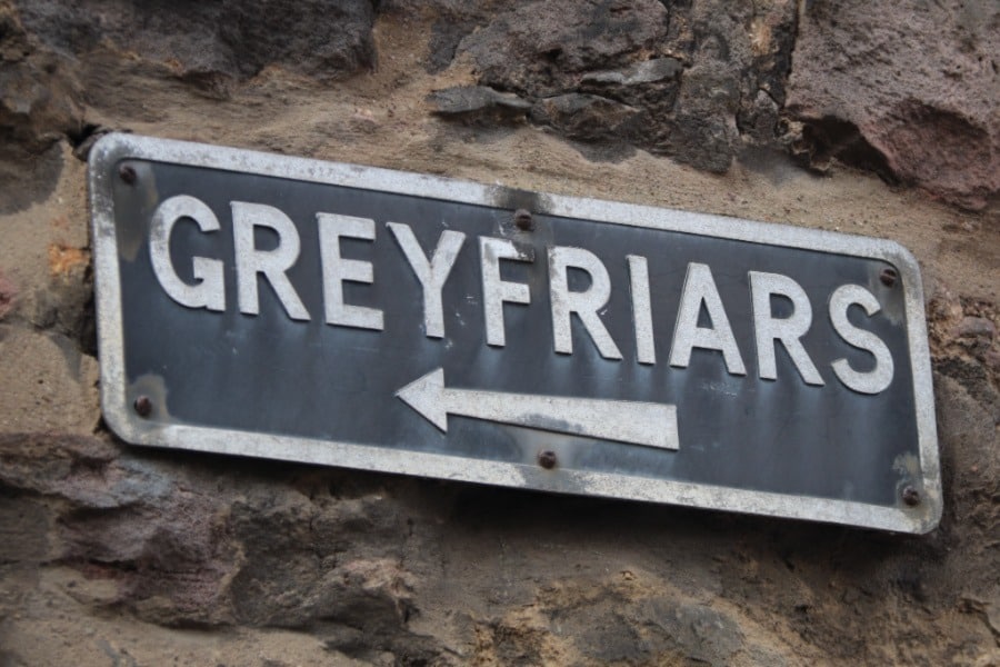 A sign directing visitors to Greyfriars Kirkyard in Edinburgh